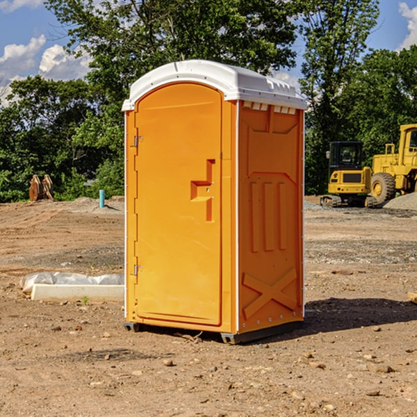 what is the cost difference between standard and deluxe porta potty rentals in Cadillac